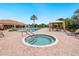 Community pool and hot tub surrounded by lounge chairs and covered cabanas with a clubhouse nearby at 12740 Del Corso Loop, Lakewood Ranch, FL 34211
