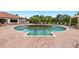 Serene community pool with sun loungers, palm trees, and island oasis in the middle at 12740 Del Corso Loop, Lakewood Ranch, FL 34211