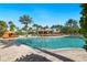 Beautiful community pool area, framed by palm trees, lounge chairs and blue skies at 12740 Del Corso Loop, Lakewood Ranch, FL 34211