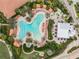 Aerial view of a large community pool surrounded by lounge chairs, palm trees, and cabanas at 12740 Del Corso Loop, Lakewood Ranch, FL 34211