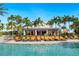View of a poolside bar surrounded by lounge chairs, and tropical landscaping at 12740 Del Corso Loop, Lakewood Ranch, FL 34211