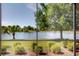 The screened-in porch offers peaceful lake views, framed by lush greenery and mature trees at 12740 Del Corso Loop, Lakewood Ranch, FL 34211