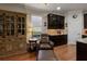 Relaxing sitting area adjacent to the kitchen with a large wooden cabinet and chair at 12740 Del Corso Loop, Lakewood Ranch, FL 34211