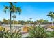 Community tennis courts surrounded by tropical landscaping and palm trees under blue skies at 12740 Del Corso Loop, Lakewood Ranch, FL 34211