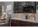 Wet bar featuring wine rack, granite countertop, and storage cabinets at 12740 Del Corso Loop, Lakewood Ranch, FL 34211