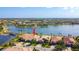 Aerial view of community homes with lake, bridge, and pool amenities; prime real estate location at 13724 Quinta St, Venice, FL 34293