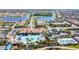 Aerial view of a Primary-planned community showcasing pools, lush landscaping, and stunning waterfront homes at 13724 Quinta St, Venice, FL 34293