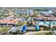 Aerial view of clubhouse, pool, and bocce ball courts in tropical community setting at 13724 Quinta St, Venice, FL 34293