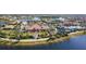 Aerial view of a community showcasing luxurious amenities including a pool, tennis courts, and lush landscaping at 13724 Quinta St, Venice, FL 34293