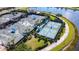 Aerial view of tennis courts, showcasing multiple courts surrounded by lush landscaping in a well-maintained community at 13724 Quinta St, Venice, FL 34293