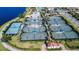 Overhead view showcasing extensive tennis facilities, multiple courts, and beautifully landscaped surroundings in the community at 13724 Quinta St, Venice, FL 34293