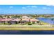 Aerial view of the home with a well-maintained lawn, lake view, and in a desirable community at 13724 Quinta St, Venice, FL 34293