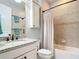 Cozy bathroom with granite countertops, tile shower, and dark bronze fixtures at 13724 Quinta St, Venice, FL 34293