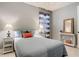 Well-lit bedroom with a large window, table lamps, and decorative pillows at 13724 Quinta St, Venice, FL 34293