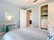 Bright bedroom featuring an open closet, modern furnishings, and blue accent walls at 13724 Quinta St, Venice, FL 34293