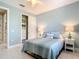 The bedroom boasts tiled floors, a closet with sliding doors, matching lamps, and beach themed décor at 13724 Quinta St, Venice, FL 34293