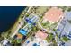 Aerial view of the bocce ball courts shaded by canopies near the lake, offering a leisurely outdoor activity at 13724 Quinta St, Venice, FL 34293