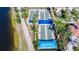 Aerial view of bocce ball courts with blue sunshades, surrounded by landscaping near a lake at 13724 Quinta St, Venice, FL 34293