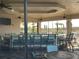 Community clubhouse bar area with seating and great views of pool and palms at 13724 Quinta St, Venice, FL 34293