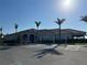 Stunning clubhouse with ample parking, beautiful landscaping, and a tile roof at 13724 Quinta St, Venice, FL 34293