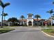 Exterior shot of a beautiful community clubhouse with lush landscaping, blue skies and sunny weather at 13724 Quinta St, Venice, FL 34293