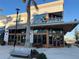 Exterior shot of Foxtail Coffee Co. featuring outdoor seating, large windows, and stylish architecture at 13724 Quinta St, Venice, FL 34293