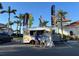 People line up at a coffee truck outside of a building on a sunny day at 13724 Quinta St, Venice, FL 34293