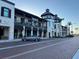 Two-story commercial building with retail shops, restaurants, covered balconies, and street-side parking at 13724 Quinta St, Venice, FL 34293