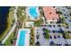 Aerial view of pools, clubhouse, and parking showcasing community amenities and landscaped grounds at 13724 Quinta St, Venice, FL 34293