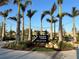 Wellen Park neighborhood sign adorned with palm trees and lush landscaping at 13724 Quinta St, Venice, FL 34293
