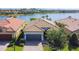 Stunning exterior shot showcases a well-manicured lawn and a charming one-story home with a tile roof at 13724 Quinta St, Venice, FL 34293