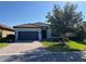 Charming single-story home featuring a tile roof, paver driveway, manicured landscaping, and a two-car garage at 13724 Quinta St, Venice, FL 34293