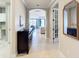 Bright hallway with decorative furnishings leads to open living spaces and gorgeous waterfront views at 13724 Quinta St, Venice, FL 34293