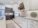 Elegant kitchen featuring custom cabinetry, stainless steel appliances, and modern finishes at 13724 Quinta St, Venice, FL 34293