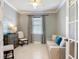 Inviting room with a calming color palette, comfortable sofa, and plenty of natural light at 13724 Quinta St, Venice, FL 34293