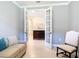A living room showcases French doors, accent chairs, and dark wood furniture adding to its appeal at 13724 Quinta St, Venice, FL 34293
