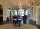 Elegant lobby area featuring high ceilings, natural light, hardwood floors and stylish furniture at 13724 Quinta St, Venice, FL 34293