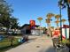 Outdoor dining and recreation area with casual seating and various food vendors on a sunny day at 13724 Quinta St, Venice, FL 34293