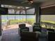 Relaxing screened-in patio featuring comfortable seating and scenic water views, creating a serene outdoor living space at 13724 Quinta St, Venice, FL 34293