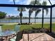 Outdoor patio with brick flooring features a gorgeous water view and tropical landscaping at 13724 Quinta St, Venice, FL 34293
