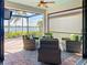 Relaxing patio with wicker furniture, views of the lake, and sun protection at 13724 Quinta St, Venice, FL 34293