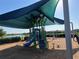 Community playground with shade and view of a lake in the distance at 13724 Quinta St, Venice, FL 34293