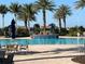 Stunning pool area featuring a gorgeous water feature, multiple lounge chairs, and palm trees, perfect for relaxing at 13724 Quinta St, Venice, FL 34293