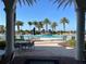 Inviting community pool area with palm trees, lounge chairs, and shaded umbrellas for a relaxing experience at 13724 Quinta St, Venice, FL 34293