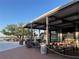 Scenic outdoor dining area with wooden tables and chairs, overlooking a serene lakeside at 13724 Quinta St, Venice, FL 34293