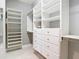 Spacious walk-in closet with custom shelving and drawer units for optimal organization and storage at 13724 Quinta St, Venice, FL 34293