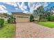 Charming home with brick driveway, lush landscaping, and an attached two-car garage at 14239 Nighthawk Ter, Lakewood Ranch, FL 34202