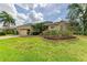 Charming home featuring a well-manicured lawn and beautifully landscaped flower beds with pink blooms at 14239 Nighthawk Ter, Lakewood Ranch, FL 34202
