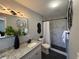 Modern bathroom featuring granite countertops, updated vanity, and walk-in shower with marble patterned tiling at 1461 17Th St, Sarasota, FL 34234