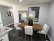 Dining room featuring a wooden table with seating for four and contemporary artwork at 1461 17Th St, Sarasota, FL 34234